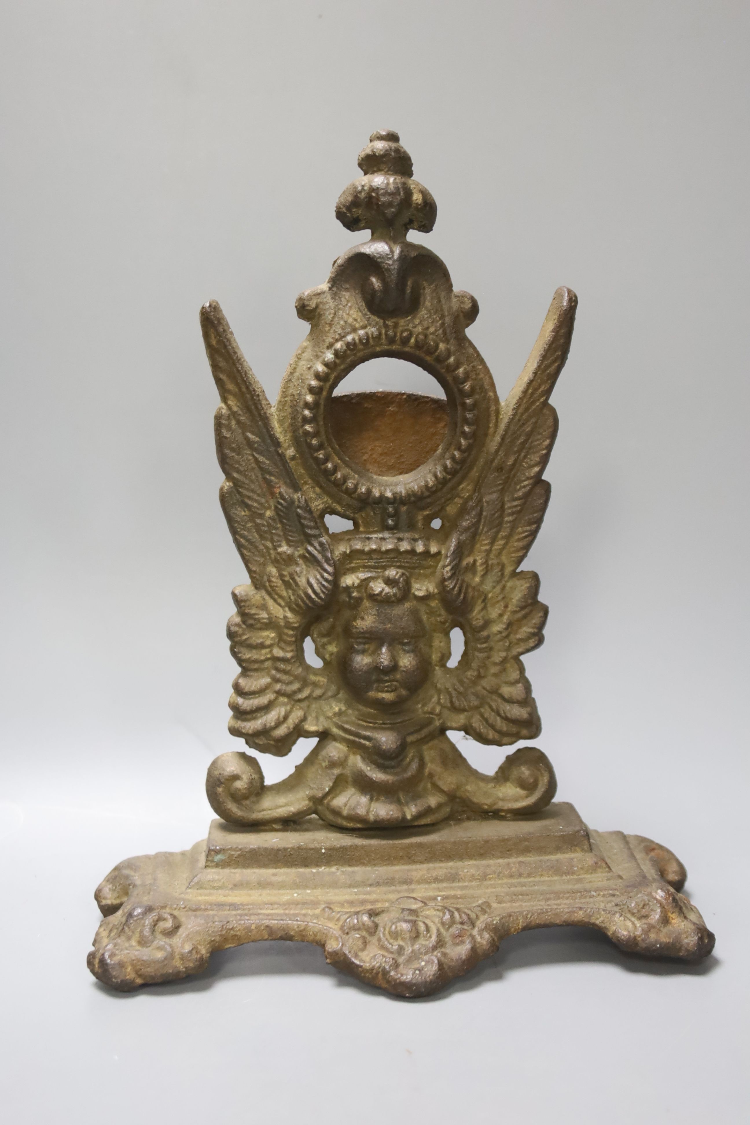 A Victorian cast watch stand and a gilt metal framed plaque